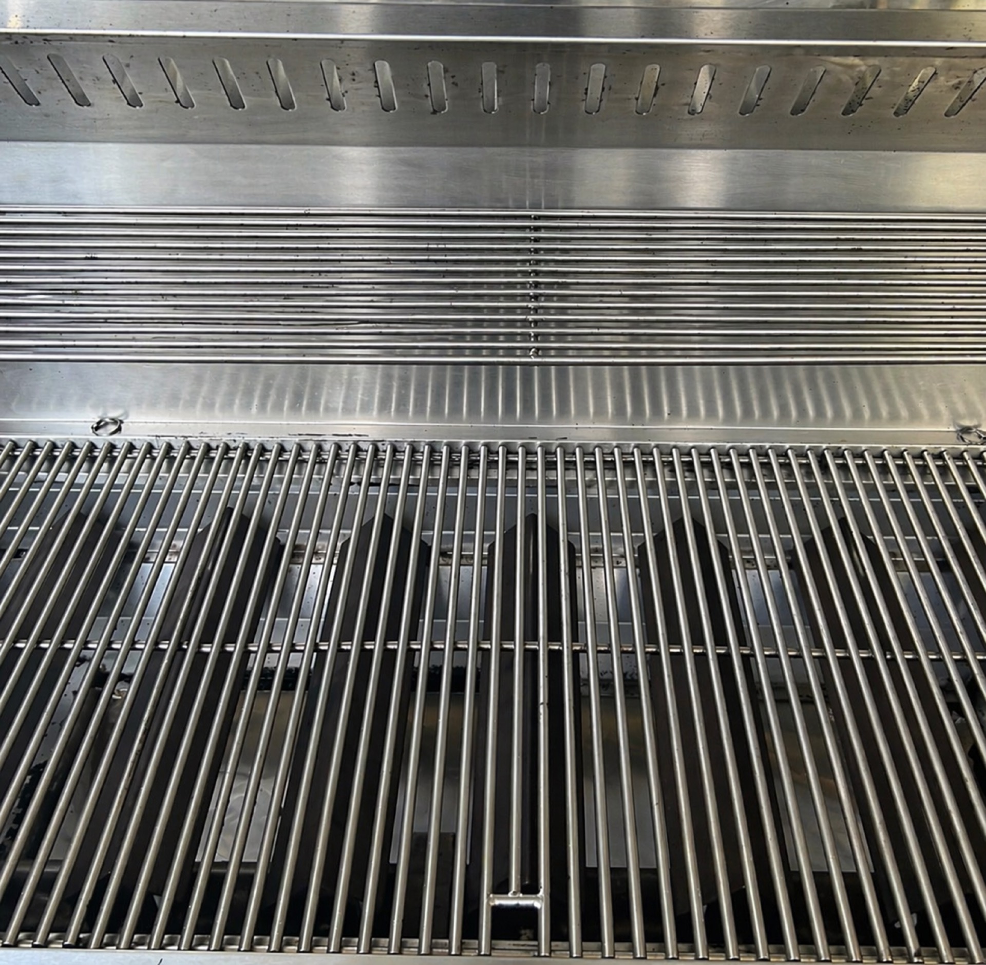 Same grates restored to a clean stainless finish after service