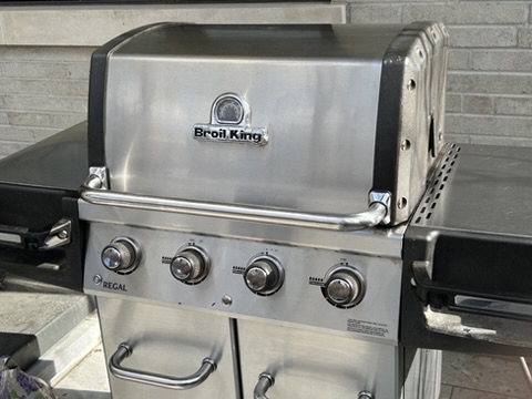 Same Broil King Regal BBQ after deep clean — mirror-polished hood and restored stainless finish
